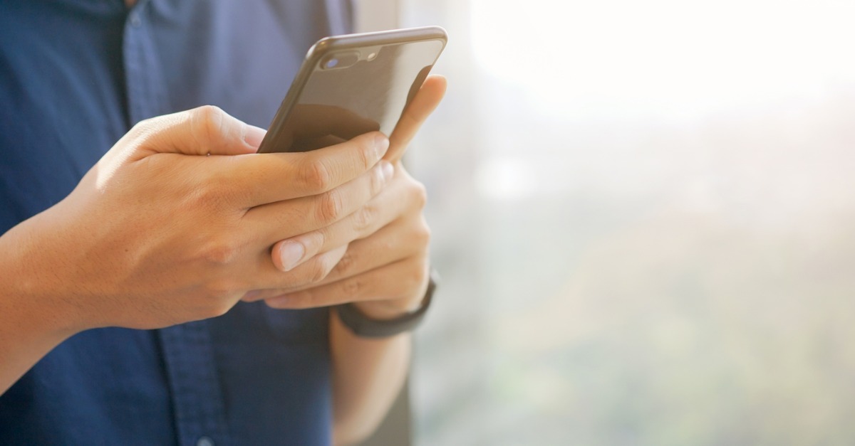 Patient holding phone for televisit.